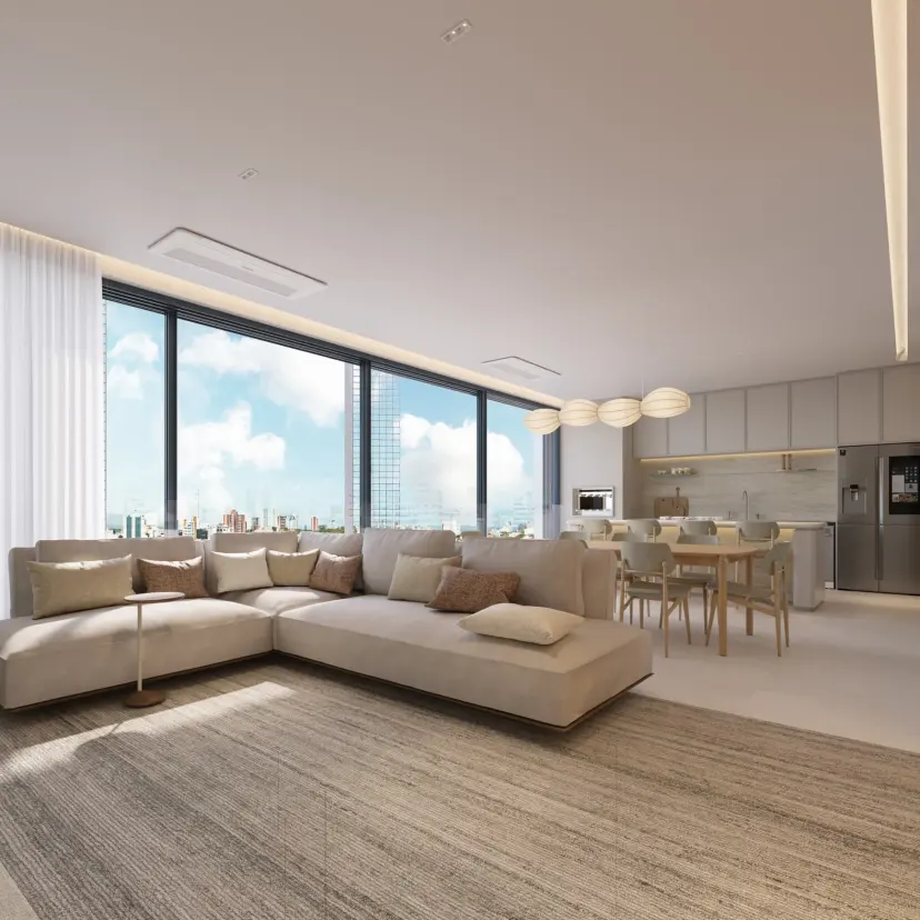 Estar do apartamento tipo com sofá modular em L, tapete de trama clara e cozinha com ilha ao fundo