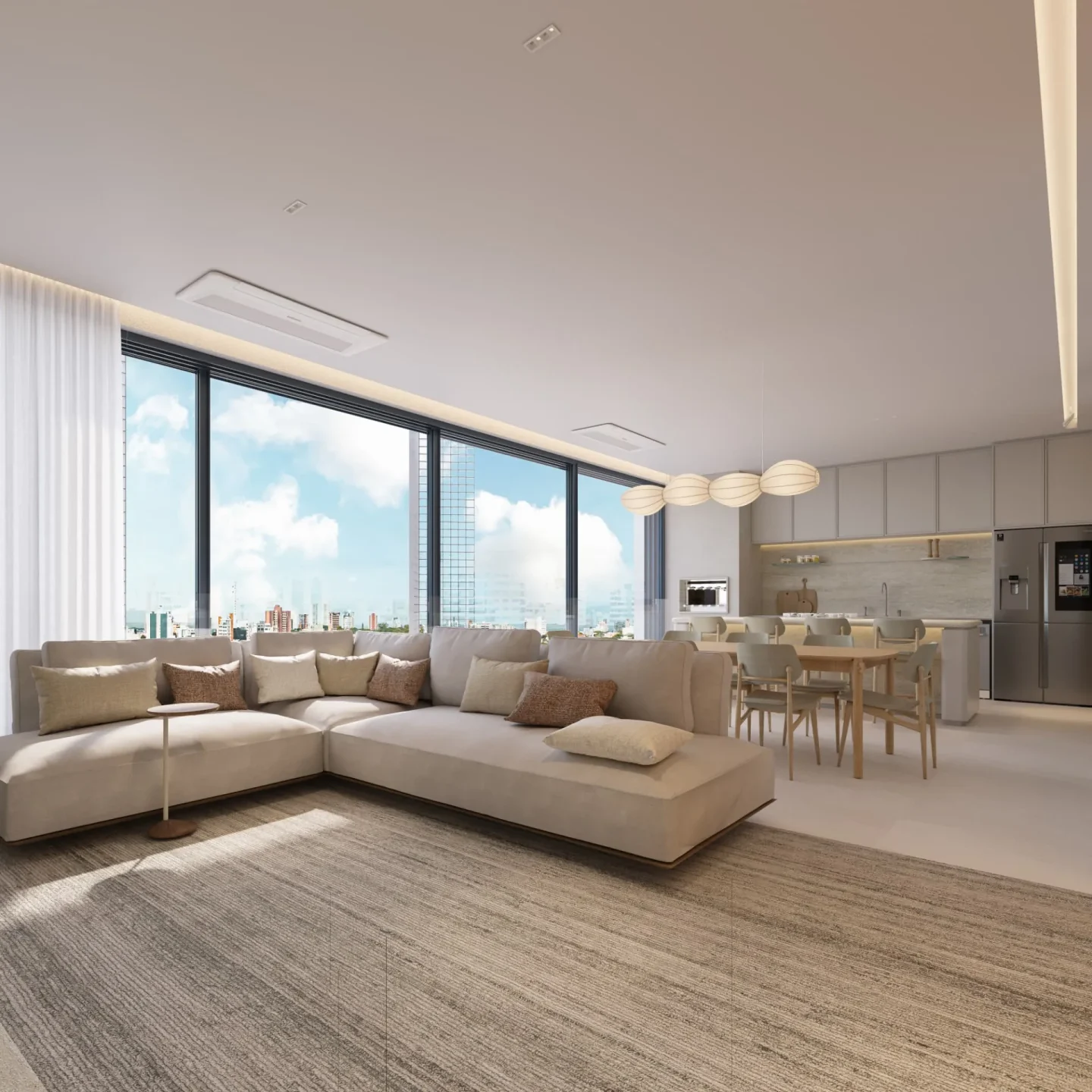 Estar do apartamento tipo com sofá modular em L, tapete de trama clara e cozinha com ilha ao fundo
